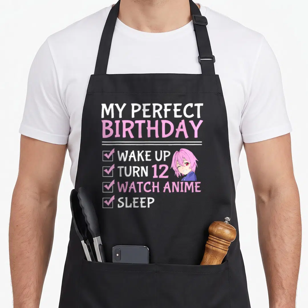 Perfect anime mom apron - My Perfect Birthday checklist with winking pink-haired anime girl in white and pink text — shown on a black cotton canvas apron against a white background