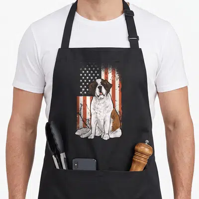 Bernard american flag apron - Seated Saint Bernard dog illustration overlaid on a distressed red white and blue USA flag — shown on a black cotton canvas apron against a white background