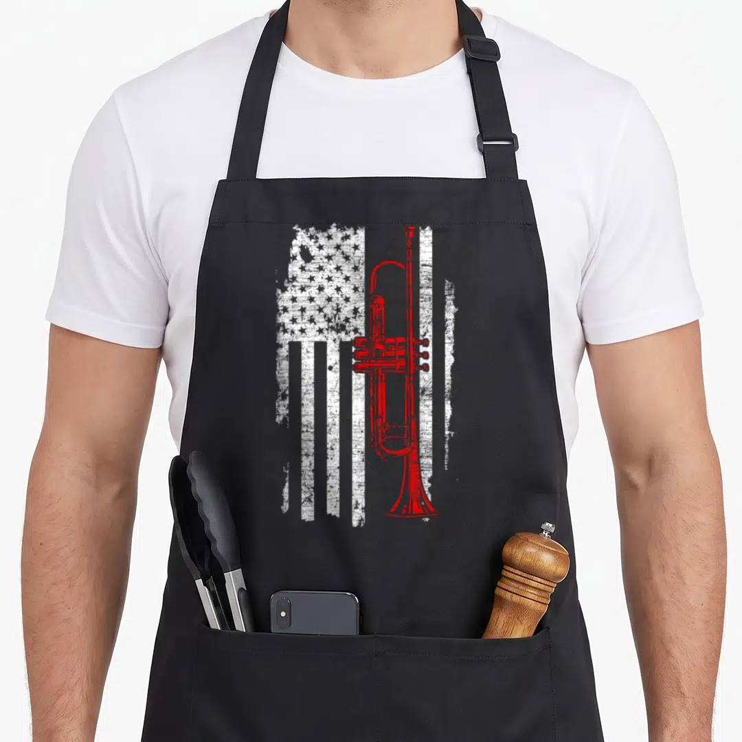 Jazz line apron - Red trumpet superimposed over distressed white USA flag pattern — shown on a black cotton canvas apron against a white background