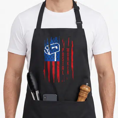 Postal patriotic apron - Distressed USA flag with white mailbox and vertical red POSTAL WORKER text — shown on a black cotton canvas apron against a white background