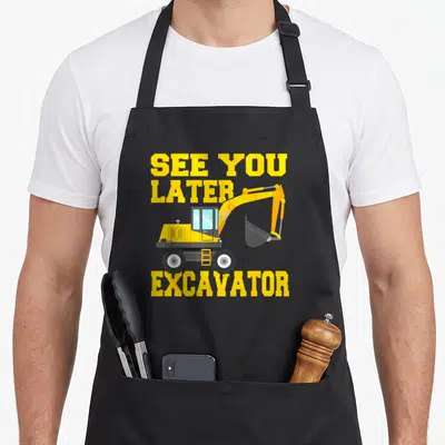 See birthday apron - Yellow excavator cartoon with See You Later Excavator text stacked vertically — shown on a black cotton canvas apron against a white background