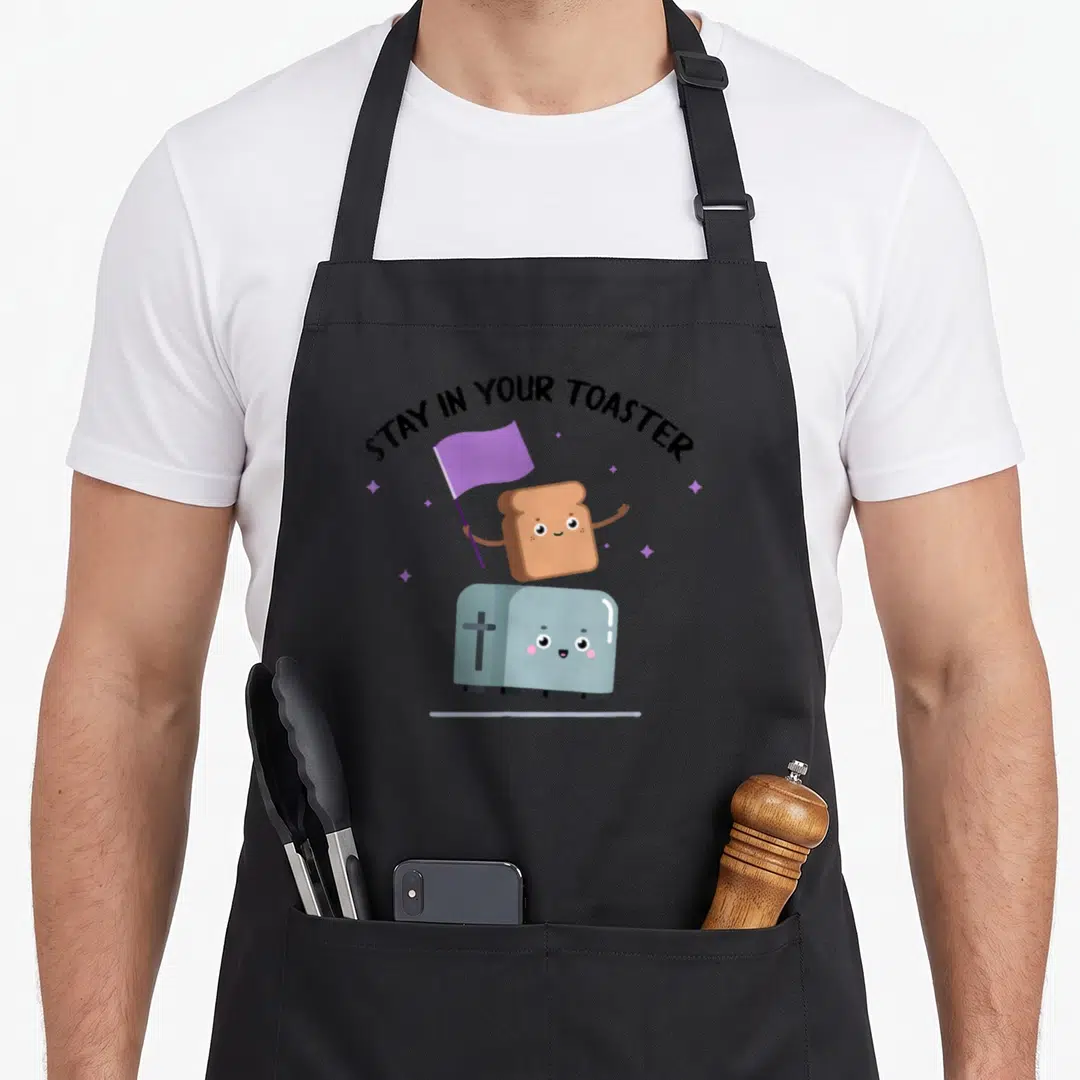 Stay color guard apron - Cartoon toast holding purple flag atop blue toaster under arched text — shown on a black cotton canvas apron against a white background
