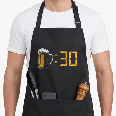 Homebrewer craft apron - Distressed beer mug next to orange :30 digital clock numbers — shown on a black cotton canvas apron against a white background