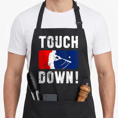Inspired baseball apron - TOUCH DOWN text above red blue rectangle with white rake silhouette — shown on a black cotton canvas apron against a white background