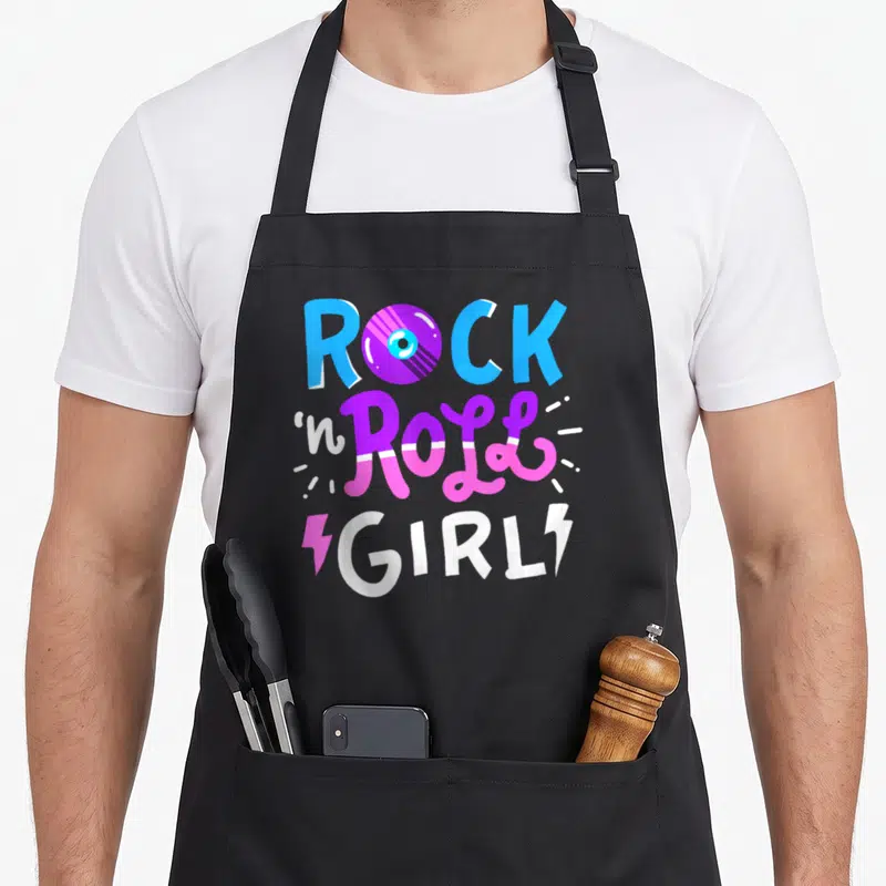 Music roll apron - Rock n Roll Girl text with vinyl record O and sparkle lines in blue purple pink and white — shown on a black cotton canvas apron against a white background