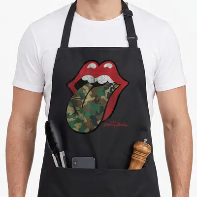 Camo rolling stones apron - Distressed red lips with camo tongue and the Rolling Stones text — shown on a black cotton canvas apron against a white background
