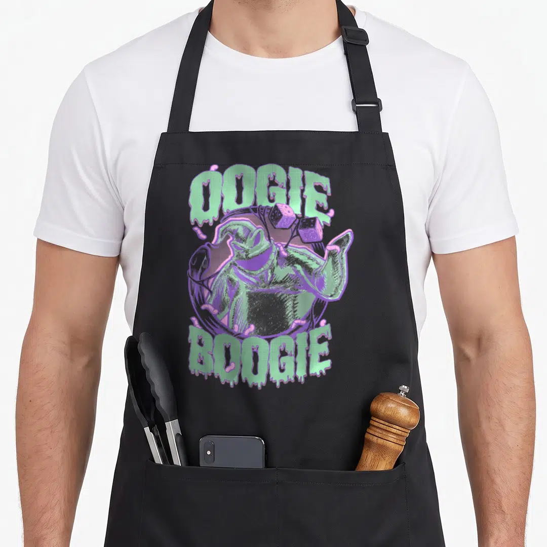 Boogie christmas apron - Oogie Boogie portrait with dice and dripping text in mint green and purple — shown on a black cotton canvas apron against a white background