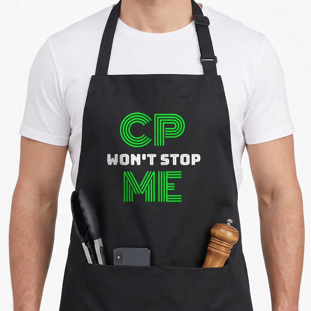 Damage ribbon mom apron - Stacked green and white text reading CP WON'T STOP ME in linear typography — shown on a black cotton canvas apron against a white background