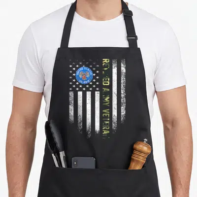 Retired army american flag apron - Distressed white flag with US Army seal and vertical olive tan text reading RETIRED — shown on a black cotton canvas apron against a white background