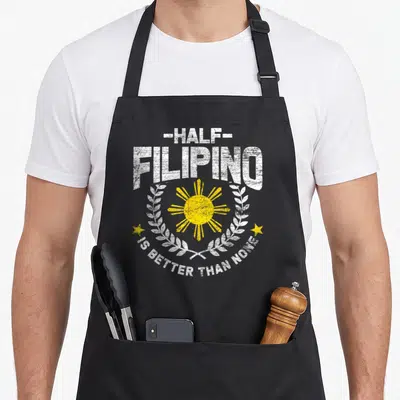 Better filipino apron - Distressed white text and yellow sun inside white wreath with two stars — shown on a black cotton canvas apron against a white background