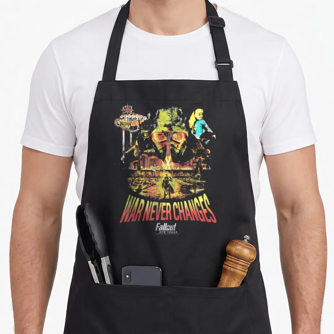 Vegas video game apron - Power armor helmet with Vegas sign and War Never Changes text in retro colors — shown on a black cotton canvas apron against a white background