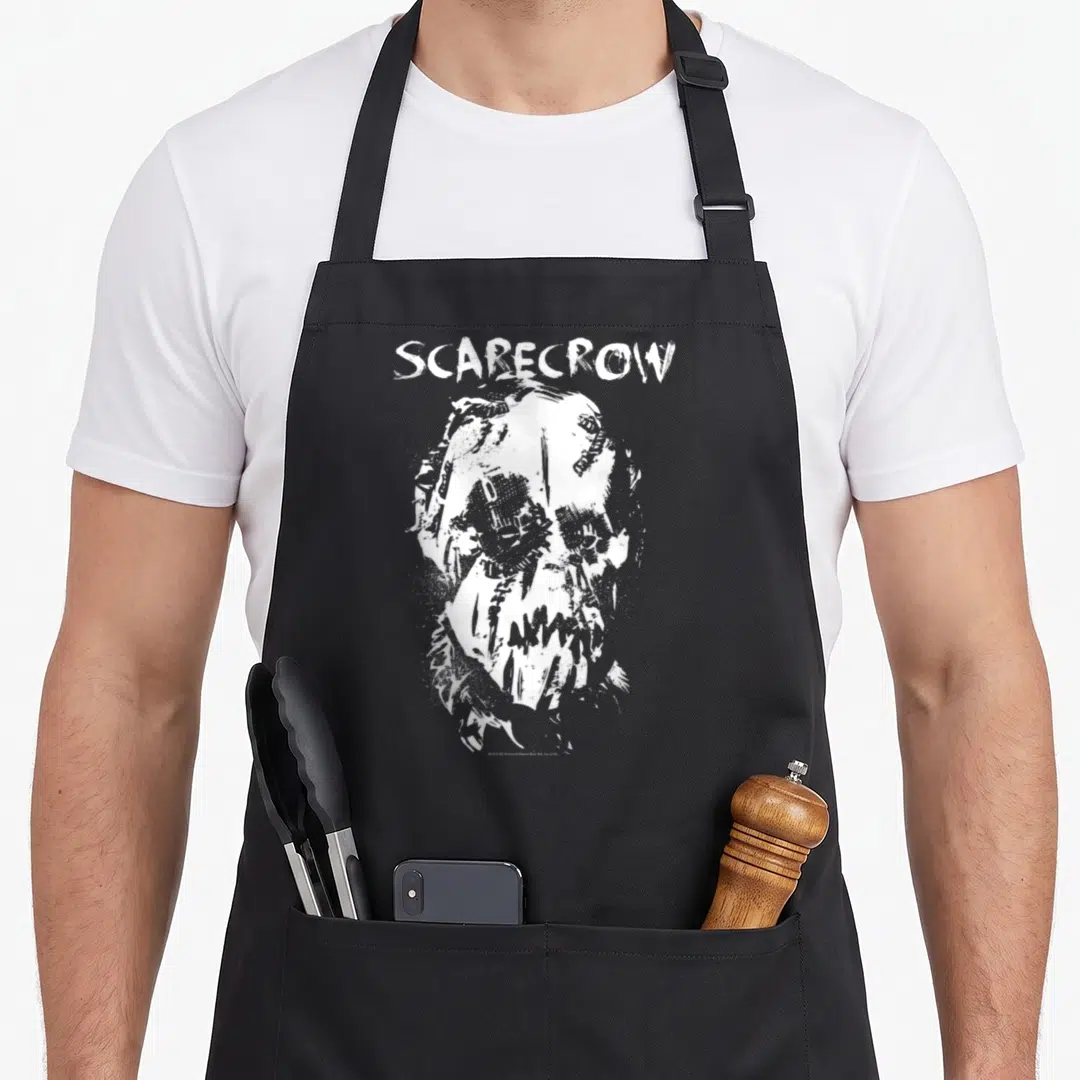 Begin face apron - White distressed SCARECROW text above a stylized burlap-masked head illustration on a dark background — shown on a black cotton canvas apron against a white background