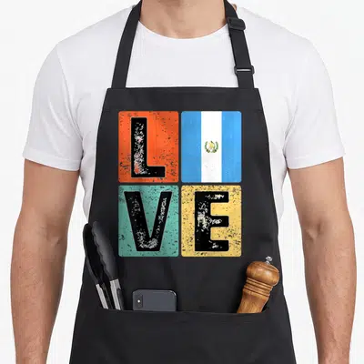 Guatemala flag pride guatemalan aprons - Distressed LOVE text with Guatemala flag replacing the O on orange, teal — shown on a black cotton canvas apron against a white background