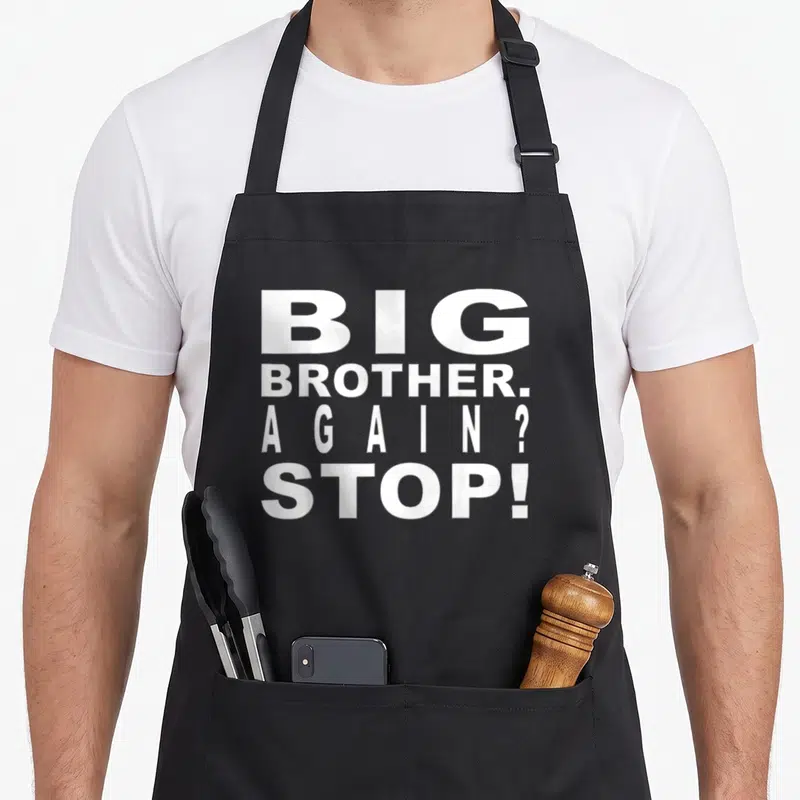 Brother sibling novelty apron - White stacked text reading BIG BROTHER AGAIN STOP on dark background — shown on a black cotton canvas apron against a white background