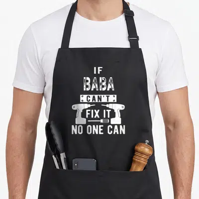Baba grandpa apron - White distressed text IF BABA CAN'T FIX IT flanked by two drills with a screwdriver below — shown on a black cotton canvas apron against a white background