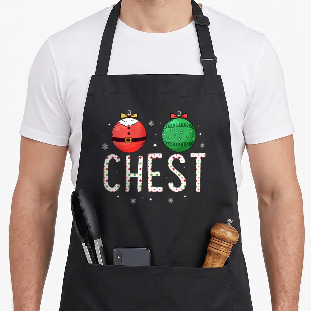 Vintage chest couples christmas aprons - Red Santa ornament and green bauble above star-patterned CHEST text — shown on a black cotton canvas apron against a white background