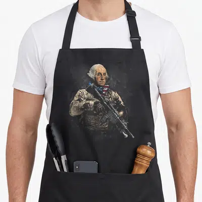 George soldier apron - Distressed portrait of George Washington in tactical vest holding rifle with red blue scarf — shown on a black cotton canvas apron against a white background