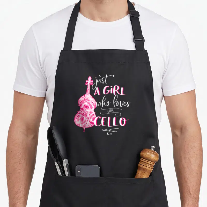 Cellist orchestra cello apron - Pink floral cello illustration beside stacked white text reading just a girl who loves — shown on a black cotton canvas apron against a white background
