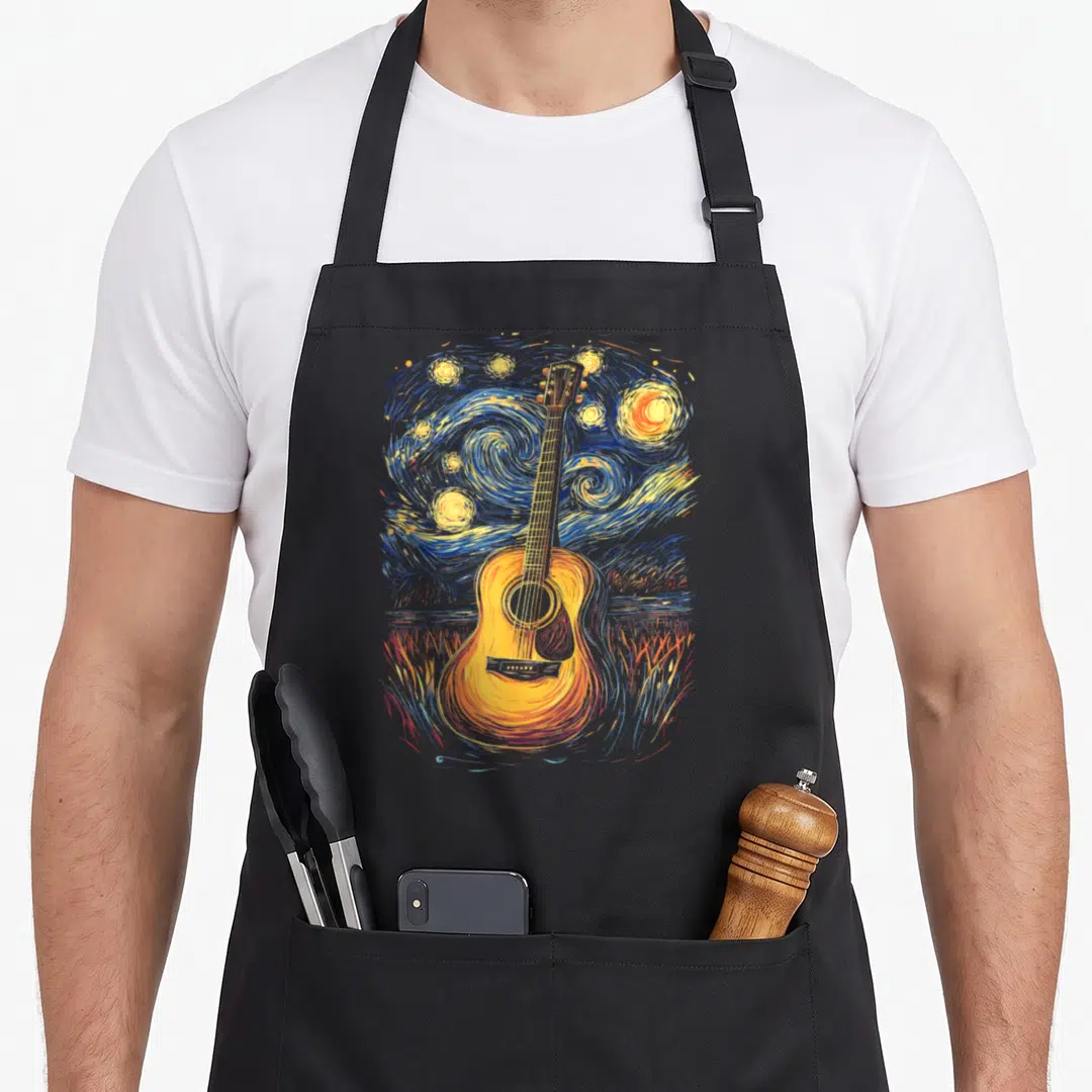 Inspired starry night apron - Watercolor acoustic guitar centered on swirling blue and yellow starry night sky — shown on a black cotton canvas apron against a white background
