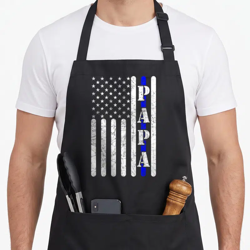 Papa police apron - Distressed US flag with vertical PAPA text over a blue stripe and white stars — shown on a black cotton canvas apron against a white background