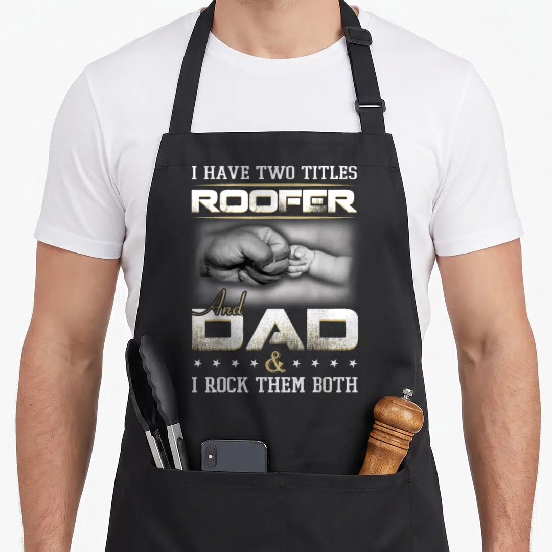 Roofer roofing apron - Distressed text 'ROOFER DAD' above and below fist-bump hands in grey and white — shown on a black cotton canvas apron against a white background