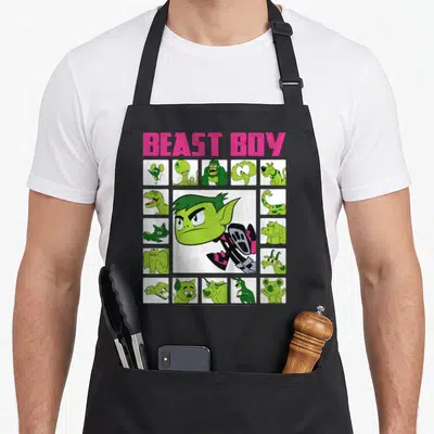 Beast box apron - BEAST BOY text above central green character and grid of fifteen animal forms — shown on a black cotton canvas apron against a white background