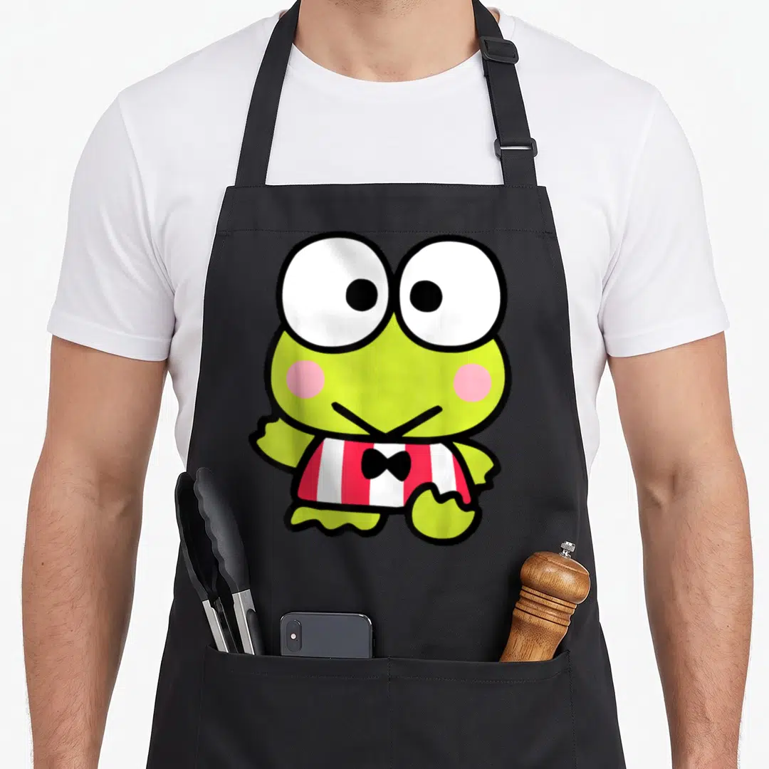 Keroppi novelty apron - Cartoon frog with large eyes, red white stripes, and black bow tie — shown on a black cotton canvas apron against a white background