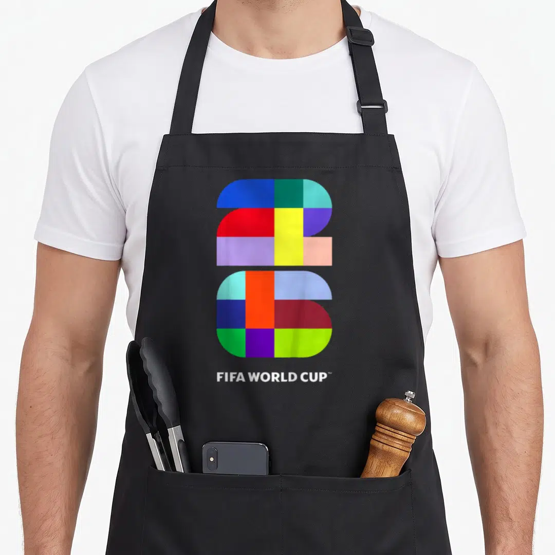 Fifa soccer birthday apron - Multicolored geometric 2026 logo above white FIFA WORLD CUP text — shown on a black cotton canvas apron against a white background