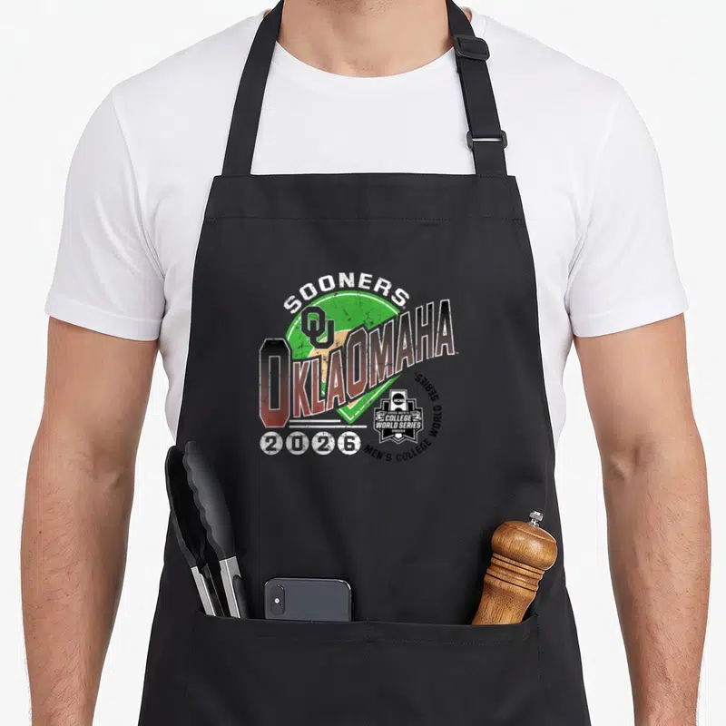 Oklahoma novelty apron - Distressed OKLAOMAHA text with OU logo, SOONERS arch, and four baseballs displaying 2026 — shown on a black cotton canvas apron against a white background