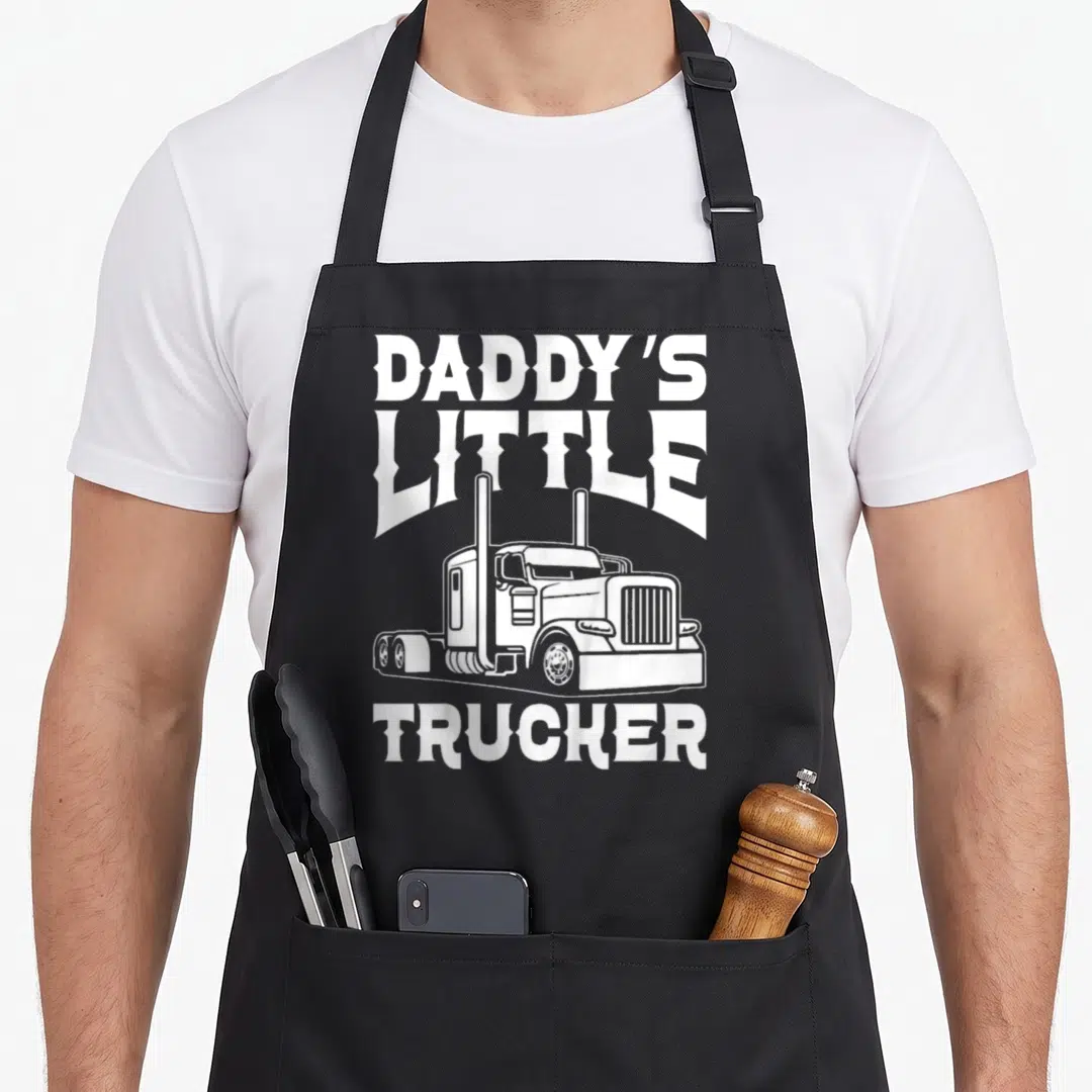 Toddler semi truck apron - White semi-truck graphic with Daddy's Little Trucker text — shown on a black cotton canvas apron against a white background