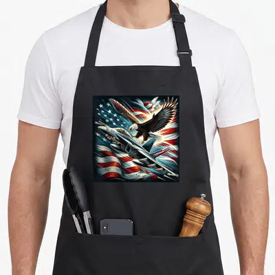Naval aviation apron - Eagle and fighter jet with ESV text over waving flag background — shown on a black cotton canvas apron against a white background