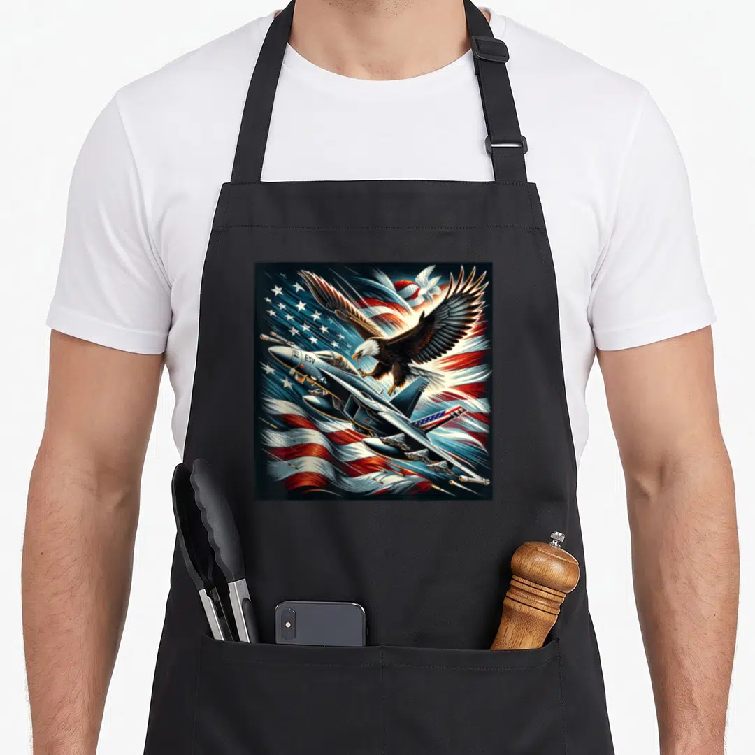 Naval aviation apron - Eagle and fighter jet with ESV text over waving flag background — shown on a black cotton canvas apron against a white background