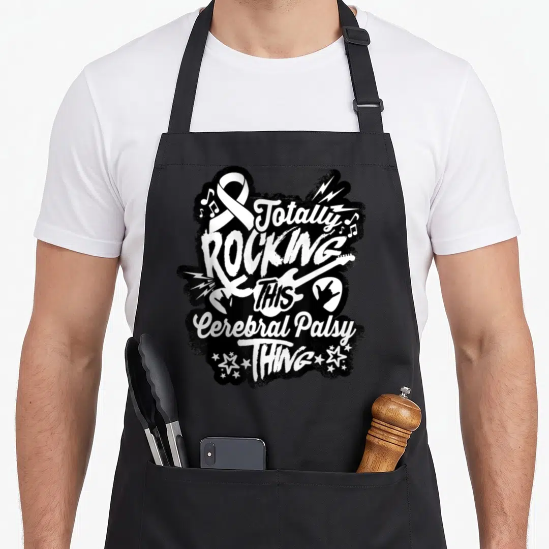 Rocking cerebral palsy awareness apron - Totally Rocking This Cerebral Palsy Thing text with electric guitar — shown on a black cotton canvas apron against a white background