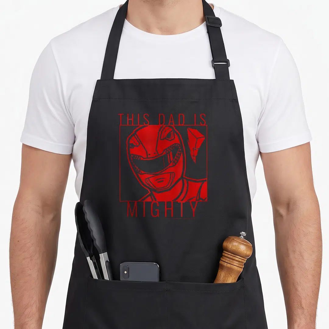 Mighty father day apron - Red line art Red Ranger head in square frame with THIS DAD IS MIGHTY text — shown on a black cotton canvas apron against a white background