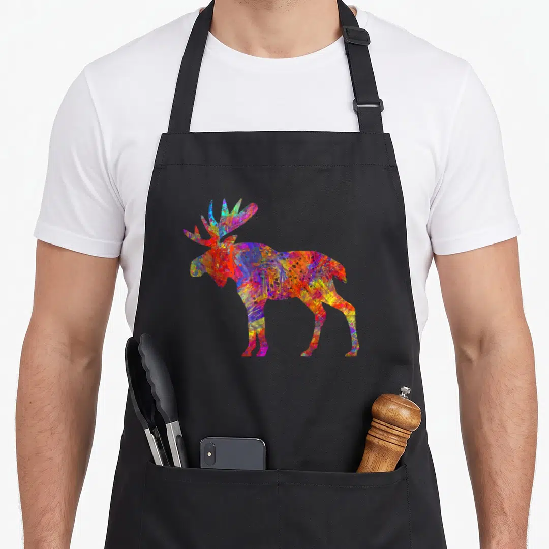 Colorful paint apron - Multicolored moose silhouette in abstract red blue yellow purple green splatter art — shown on a black cotton canvas apron against a white background