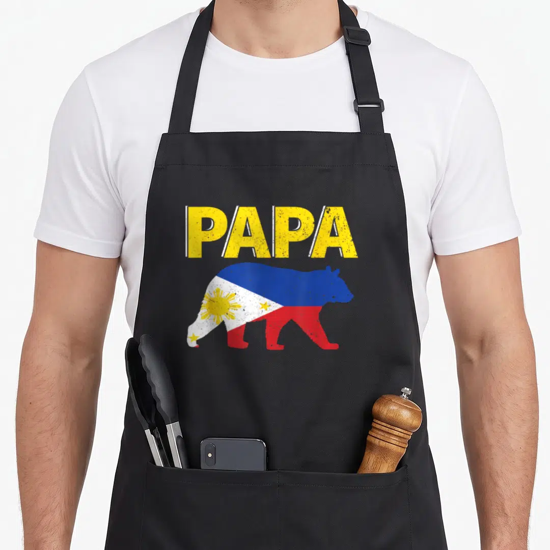 Philippine bear apron - PAPA text above bear silhouette filled with Philippine flag colors and sun symbol — shown on a black cotton canvas apron against a white background