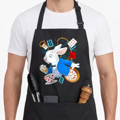 Alice wonderland rabbit apron - White rabbit in blue jacket holding gold pocket watch surrounded by playing cards — shown on a black cotton canvas apron against a white background