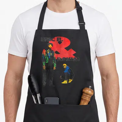 Eric novelty apron - Eric B. standing and Rakim crouching with red ampersand and multicolor graphic print — shown on a black cotton canvas apron against a white background