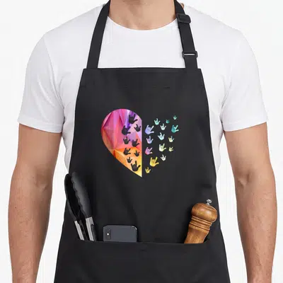 Deaf asl sign for apron - Low poly heart split into solid facets and scattered I love you hand signs in pink purple — shown on a black cotton canvas apron against a white background