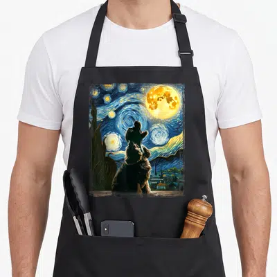 Van cocker spaniel apron - Cocker Spaniel howling at yellow moon with blue swirling stars and cypress tree — shown on a black cotton canvas apron against a white background