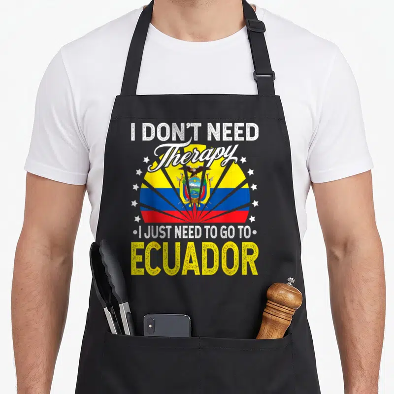 Vacation ecuador apron - Ecuador flag with sunburst rays and text I don't need therapy just need to go to ecuador — shown on a black cotton canvas apron against a white background