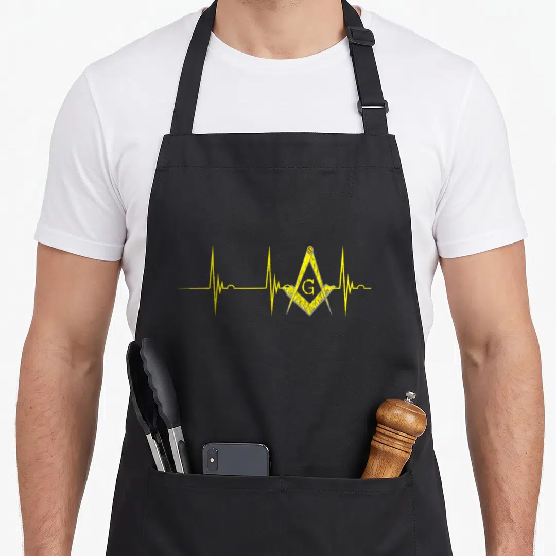 Heartbeat mason apron - Yellow distressed EKG line with square compass symbol containing letter G — shown on a black cotton canvas apron against a white background