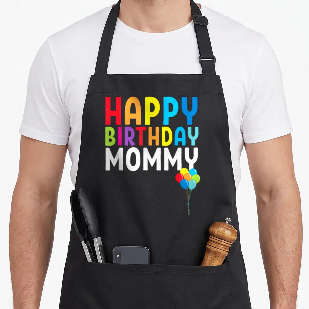 Funny toddler birthday apron - HAPPY BIRTHDAY MOMMY text with colorful balloons — shown on a black cotton canvas apron against a white background