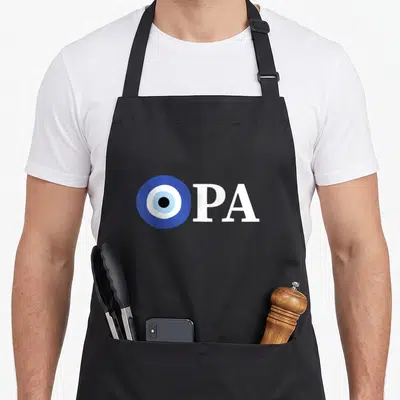 Pride greek aprons - Blue white evil eye symbol next to white OPA text on black fabric — shown on a black cotton canvas apron against a white background
