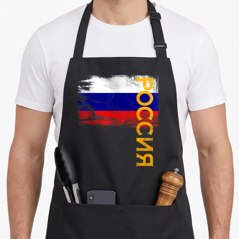 Flag russian apron - Distressed Russian flag with vertical yellow Rossiya text overlay — shown on a black cotton canvas apron against a white background