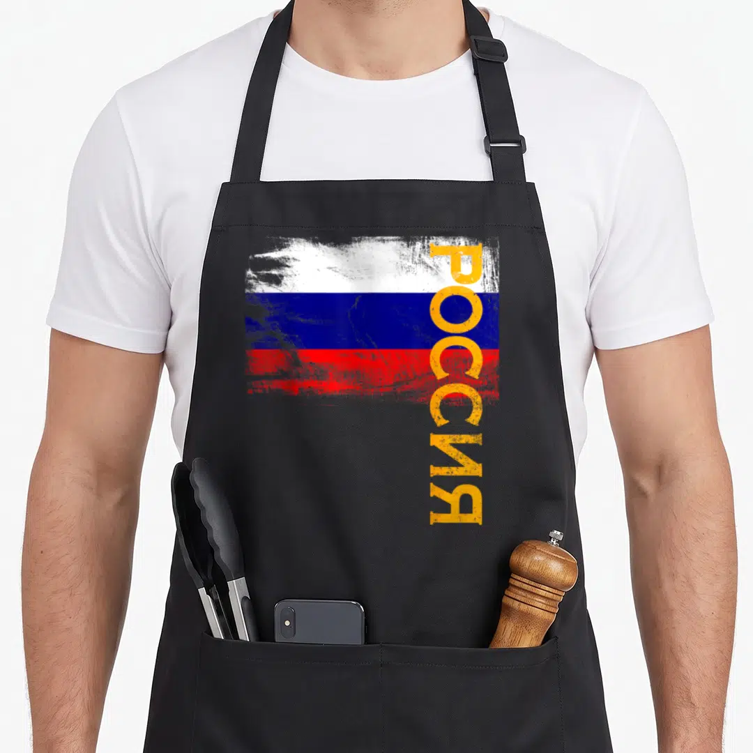 Flag russian apron - Distressed Russian flag with vertical yellow Rossiya text overlay — shown on a black cotton canvas apron against a white background