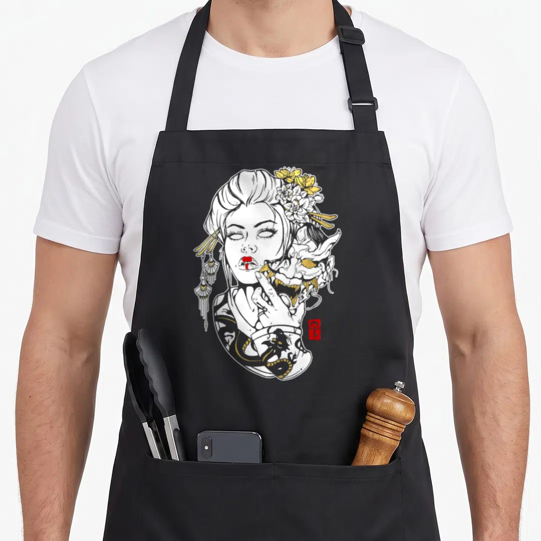 Succulent skull apron - Line art woman with yellow flowers and dragon tattoo holding a demon mask — shown on a black cotton canvas apron against a white background