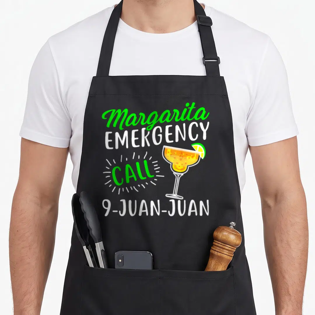 Margarita michelada apron - Margarita Emergency Call 9-Juan-Juan text with cartoon margarita glass and lime wedge — shown on a black cotton canvas apron against a white background