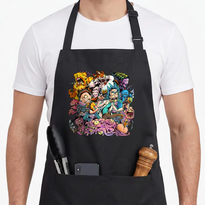 Brian general apron - Cartoon characters fighting monsters in pink blue yellow purple — shown on a black cotton canvas apron against a white background