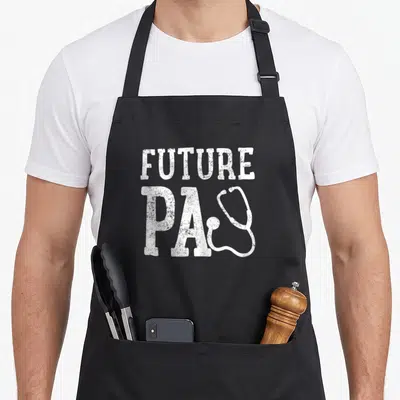 Vintage future doctor apron - White distressed FUTURE PA text with overlapping stethoscope graphic — shown on a black cotton canvas apron against a white background